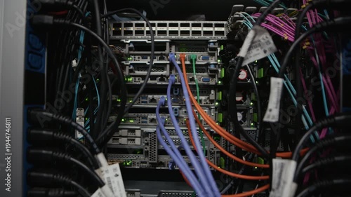 Closeup of network switch with multiple ethernet cables connected to ports inside data center server rack, close up shot showing internet infrastructure hardware and data transmission equipment