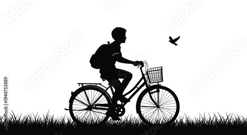 A boy silhouette rides a bicycle above grass with a bird.