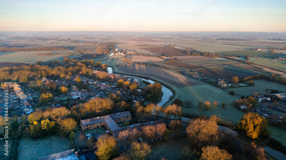 Fototapeta premium Rural farmland and English village town, Lincolnshire. Sunset in the countryside