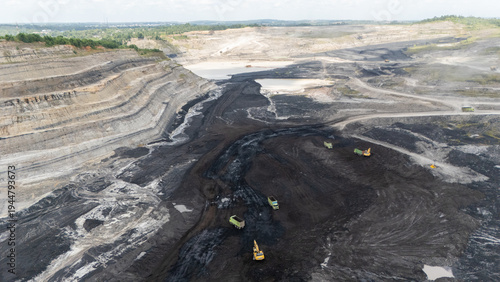 Foto Drone footage from a coal mining site in South Kalimantan shows trucks and heavy