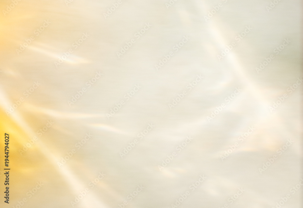 Obraz premium Soft warm golden sunlight reflections on neutral textured background