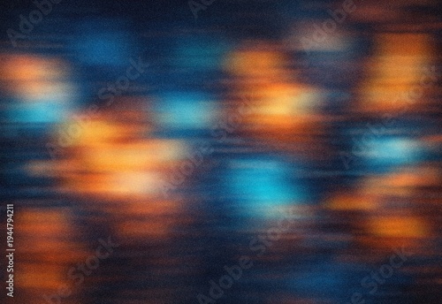 фотографія Blurred blue and orange city light reflections streaking across night water