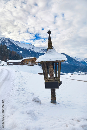 Wallpaper Mural Beautiful winter panorama with wayside cross near Bramberg am Wildkogel, in the Salzburg region, Austria. Torontodigital.ca