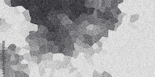 Abstract grayscale mosaic with irregular polygonal shapes and a speckled noise effect, creating a unique textured background for digital art and design applications