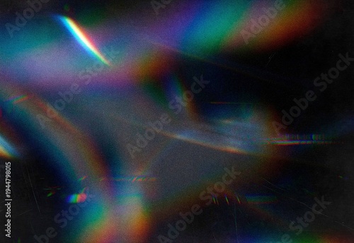 Iridescent prism light leaks and rainbow glare on dark grainy background