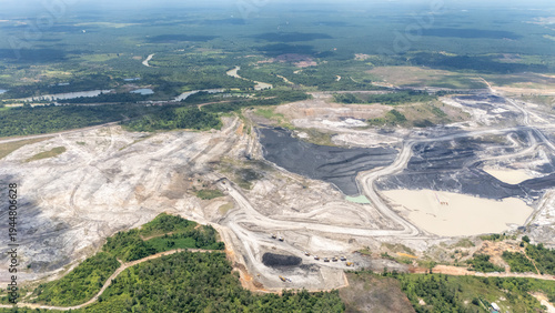 Tablou pe pânză Drone shoot of a coal mining area near a residential area and nearby a blue lake from a former coal mine in South Kalimantan