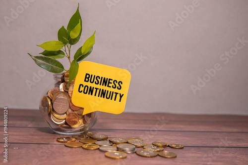 Φωτογραφία Money tree, coins, and the inscription Business Continuity on a sticker