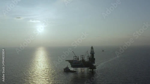 Aerial view of offshore jack up rig and offshore platform for oil and gas exploration and production. 
