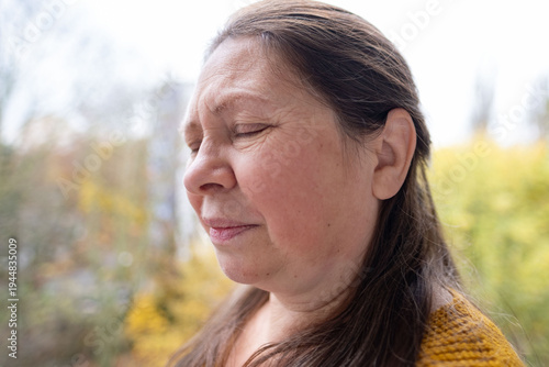 Middle-aged woman suffering from grief and pain. Emotional portrait, deep sadness, human emotion. Ideal for loss and mourning themes