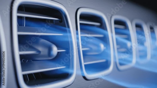 A close-up view of four air vents with blue-tinted air blowing out, creating a sense of movement and modernity