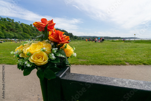 фотографія Memorial bench, artificial flower