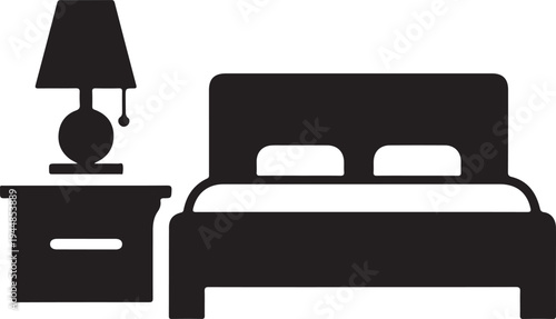 Bed with white sheets illuminated by bedside lamp