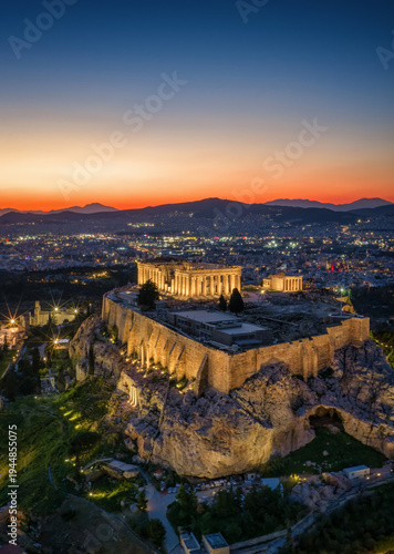 Aerial view of the illuminated Parthenon Temple at the Acropolis of Athens, Greece, during evening time