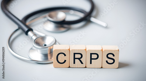 stethoscope and wooden cube with the letters CRPS or the word complex regional pain syndrome