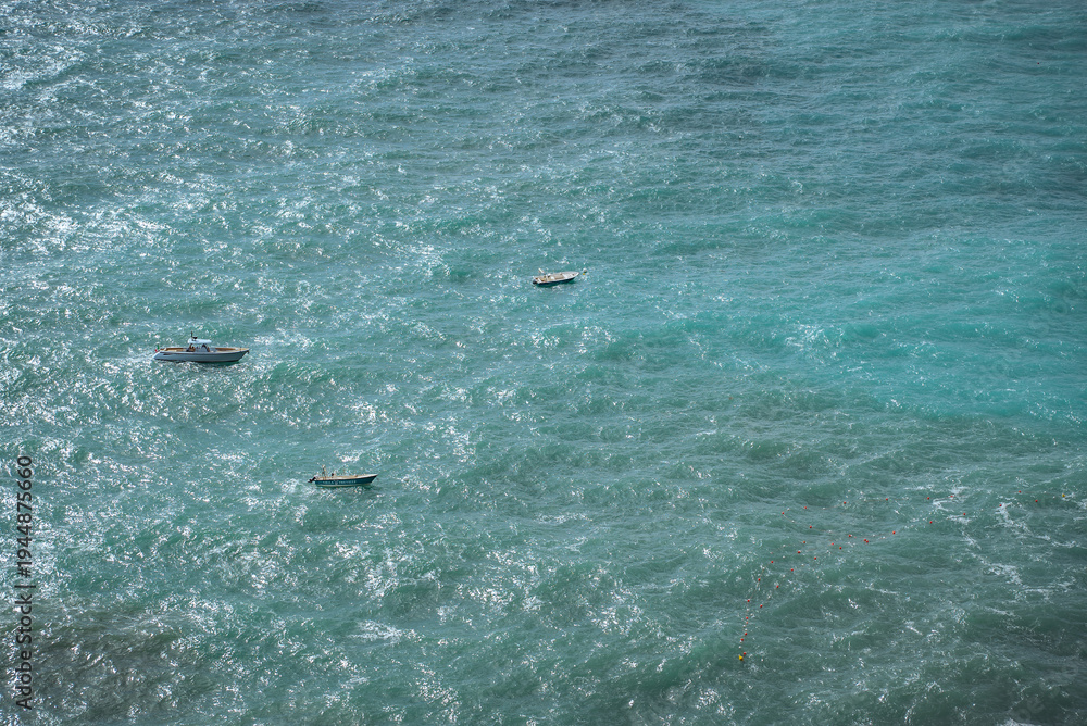 Fototapeta premium San Lazzaro, Amalfi Coast, Italy: Three boats on choppy turquoise ocean water