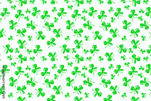 A vibrant green shamrock pattern featuring various sizes of three-leaf clovers scattered randomly across a clean white background, creating a festive and lucky design perfect for Irish celebrations.