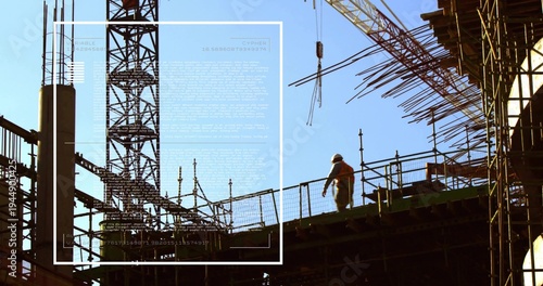 Walking site worker hardhat hi-vis vest navigating deck at building site, tower-crane, copy space