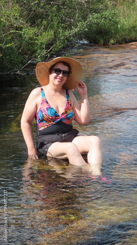 woman sitting on the lake
