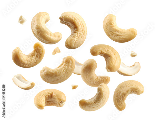 Isolated image of scattered cashew nuts in varying sizes and positions on a dark, transparent background