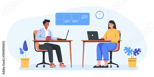 Two colleagues collaborate on laptops in a modern office workspace