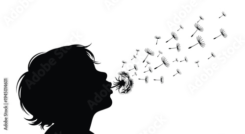 Silhouette of a child blowing dandelion seeds into the wind