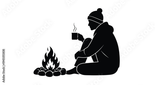 Silhouette of a person warming by a campfire with a hot drink