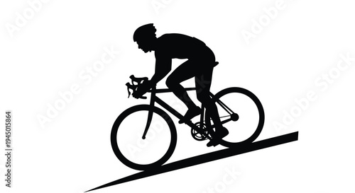 Silhouette of a cyclist riding uphill on a steep slope