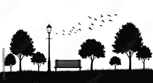 A silhouetted park scene with trees a bench and flying birds
