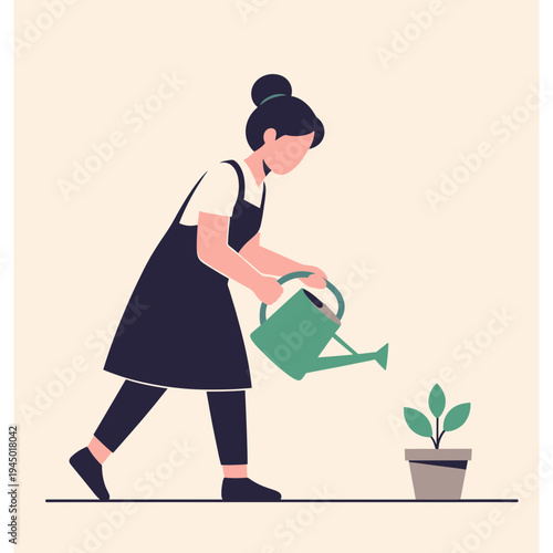 Woman watering plant with green can in garden