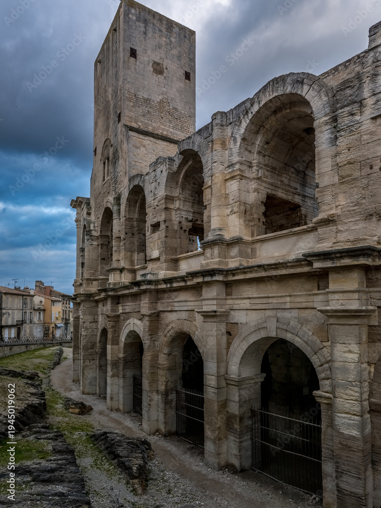 Fototapeta premium Arches of the Roman Amphitheater in Arles with medieval tower