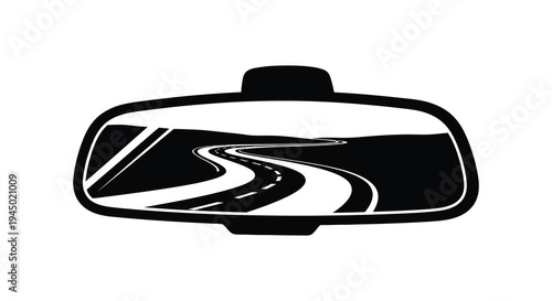 A winding road is reflected within a rearview mirror creating a striking silhouette high quality professional