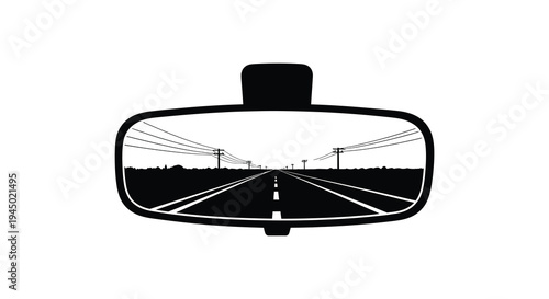 A view through a car s rearview mirror depicts a long straight road fading into the distance silhouette