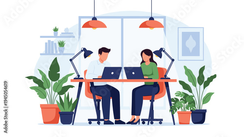 Coworkers discussing a project while working on their laptops in a bright and comfortable modern office environment.