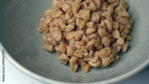 Close-up movie of crushed natto (fermented soybeans) in a Japanese dish in Japan at 60fps