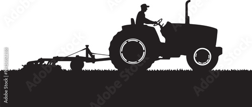 Black silhouette of man driving tractor with plow