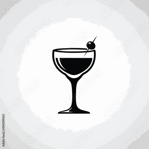 Silhouette of a cocktail in a coupe glass, garnished with an olive on a pick