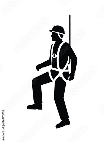 Silhouette of a construction worker wearing a safety harness and helmet ascending stairs