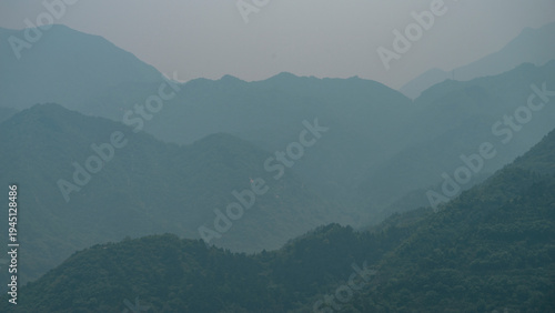 Foto Misty Green Mountain Ridges, Atmospheric Nature Background with copy space