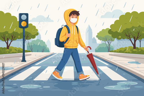 Flat vector illustration of a student wearing a face mask and yellow hoodie walking across a crosswalk on a rainy day. Boy with backpack and umbrella crossing the street in a city landscape.