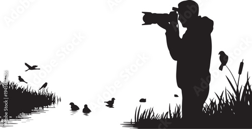 Silhouette of man photographing birds by water photographer