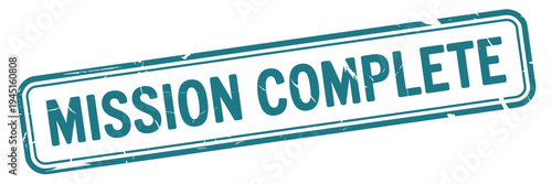 A teal rectangular stamp displaying the words mission complete in bold text