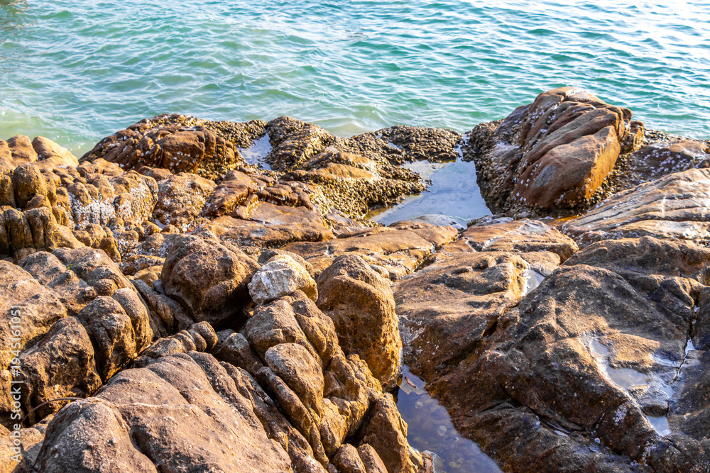 Obraz premium Kalim Beach seascape blue turquoise clear water waves rocks Thailand.