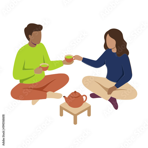 A man and woman sit cross-legged on the floor sharing a tea moment