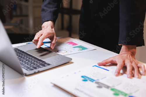 Business person working on laptop analyzing data charts