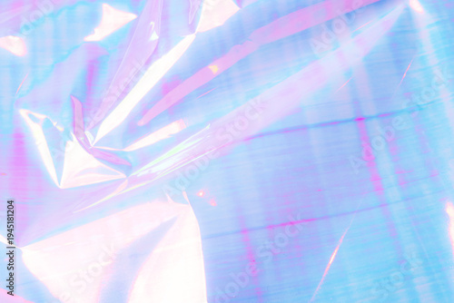 A vibrant abstract background featuring crumpled foil with a pastel gradient of pink, blue, and purple hues.