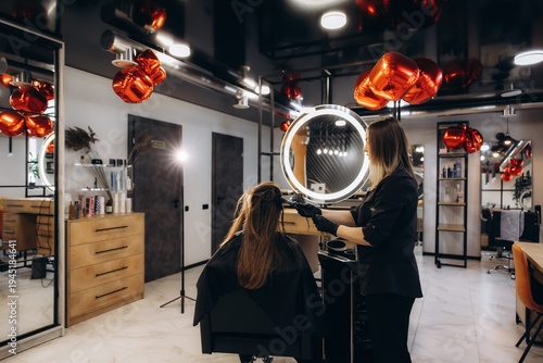 Photos Hairstylist coloring client hair in modern beauty salon