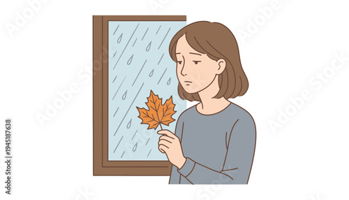A woman holding a leaf and looking out the window on a rainy day