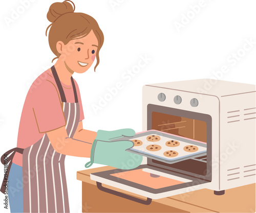 Woman taking cookies out of oven in kitchen wearing apron and gloves