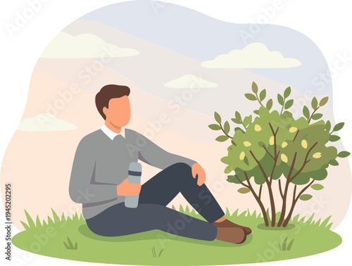 Man sitting on grass under tree with bottle outdoors