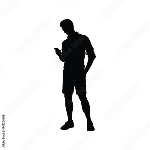 Modern Lifestyle Silhouette of a Man Standing and Looking Down at His Smartphone Screen for Social Media or Communication